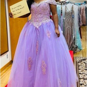 The dress is a lilac princess prom dress. The size is an 18.